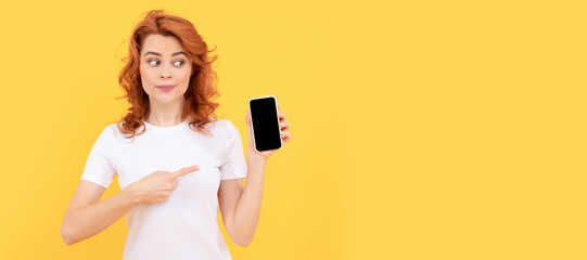 Woman isolated face portrait, banner with mock up copy space. Packed with features. pointing finger cell phone. show mobile device. presenting product.