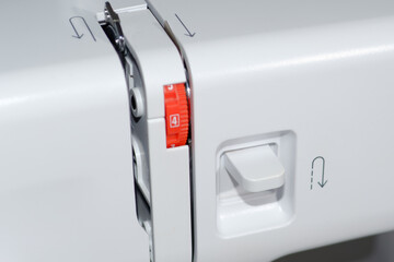 Sewing machine. Close-up reverse stitch button.