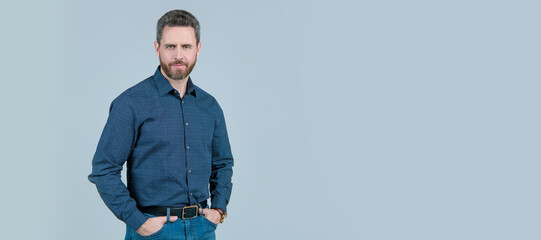 Fashion model wear stylish shirt with casual jeans posing with arms in pockets, wardrobe, copy space. Man face portrait, banner with copy space.