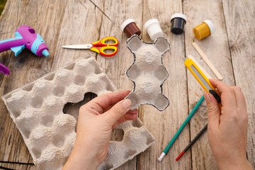 Step by step diy process. Step 3- we cut out a teddy bear figurine from an egg cardboard box....
