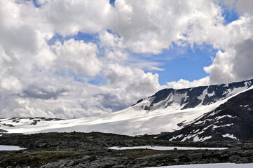 Sognefjell, Jotunheim, Norway - rocky landscape with snow in a natural park. Snow-covered rocks, mountains and icy lakes.