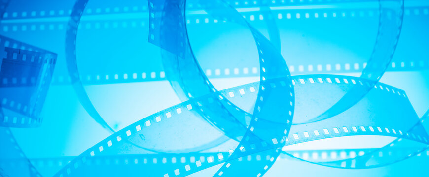 film strip and film roll on blue background isolated for desktop wallpaper banner.film production media festivals concept
