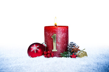 first sunday of advent red candle with golden metal number one red decoration one on  snow isolated background