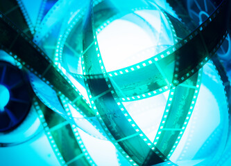 film strip and film roll on blue background isolated for desktop wallpaper banner.film production...