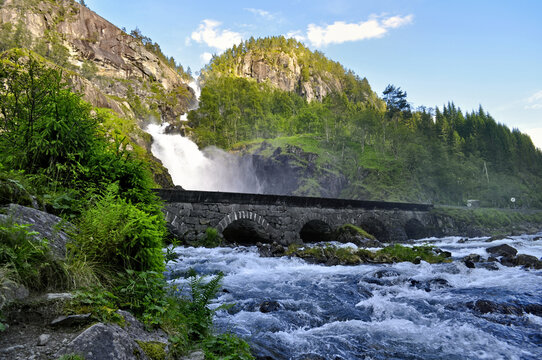 Latefossen waterfalls in Norway. A stone bridge with a road over a waterfall in the mountains.