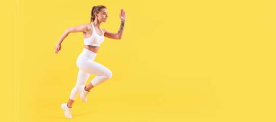 fitness girl runner running on yellow background with copy space. Woman jumping running banner with...