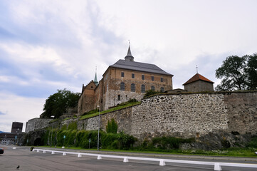 Fototapeta na wymiar Oslo, Norway - Akershus Castle, an old fortress on the fjord embankment with a high stone wall.