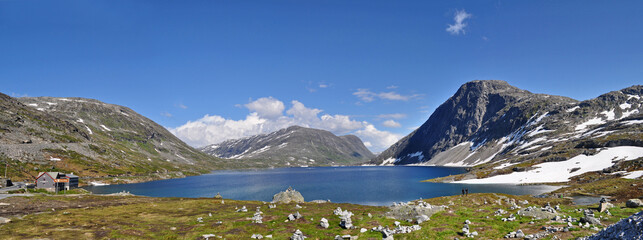 Fototapeta na wymiar High rocky mountains, lake and road in Romsdal region, Norway