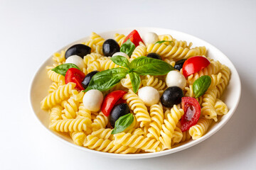 Italian cold pasta salad or Pasta fredda alla caprese. Directly above. Fusilli, tomato, mozzarella,...