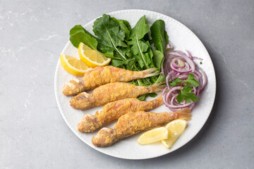 Plate of fried small fish red mullet and lemon