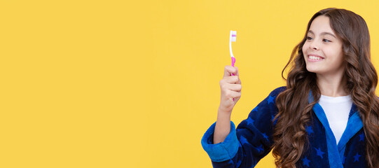 using best toothpaste. childrens stomatology. teen girl with toothbrush and apple. Banner of child girl with teeth brush, studio portrait, header with copy space.