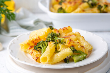 Pasta baked with broccoli and chicken. Broccoli, cheese and gratin sauce on baked penne pasta.