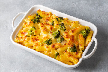 Pasta baked with broccoli and chicken. Broccoli, cheese and gratin sauce on baked penne pasta.