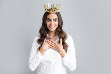 Young woman queen wear golden crown, isolated gray background.