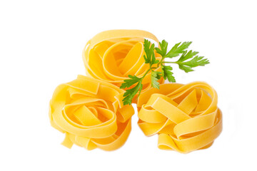 Homemade egg pasta tagliatelle. Raw nest noodles, uncooked ribbon fettuccine, dry long rolled macaroni isolated on white background top view