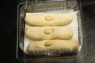  Closeup shot of freshly cooked long cookies with almonds on top in a transparent plastic packaging © Luis Alfredo Gonzalez Calkech/Wirestock Creators