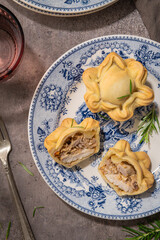 Tasty homemade baked chicken pies on plate