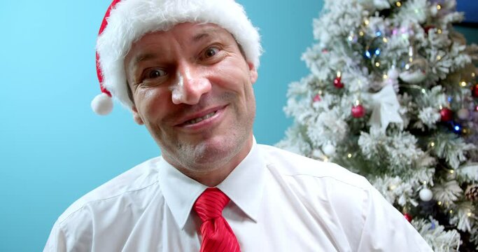 Portrait Serious dad Middle Aged in Christmas hat Santa Claus Man saying threatening with his fist, looks in camera, disappointed man's face, bad, man emotion something unpleasan. Concept man fist