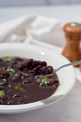 Black bean soup or stew. Latin American or Mexican cuisine.