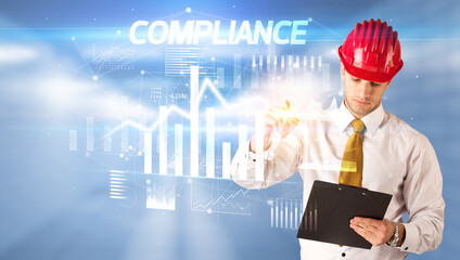 Young businessman with helmet drawing on virutal screen