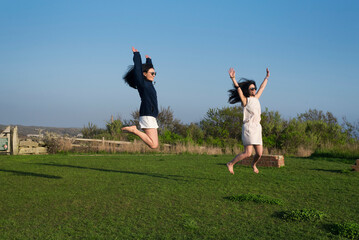 two happy chinese women jumping