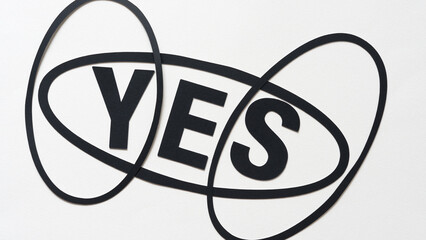 yes and oval rings or forms on white paper