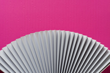 grungy decorative paper fan detail and pink paper with embossed pattern