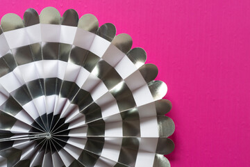 grungy decorative paper fan on hot pink background