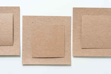 layered plain brown paper cardboard shapes on blank paper