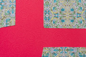 paper background featuring fancy envelope liners on red paper with old roses