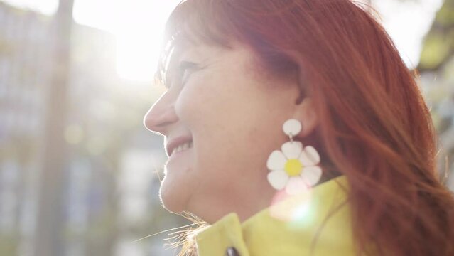 Beautiful moving portrait of attractive older female looking around the city, in slow motion 
