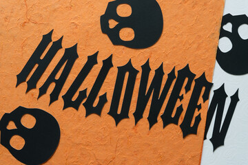 black paper skulls and the word halloween