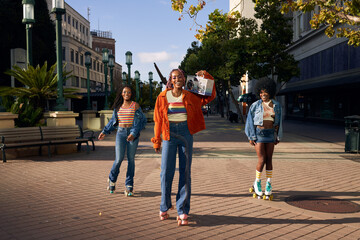 Portrait of young friend group together in the city on rollerskates
