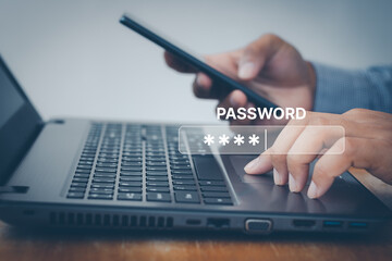 Cyber security concept. Businessman's hand enter a one time password for the validation process,...