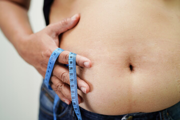 Asian woman show fat belly big size overweight and obesity at office.