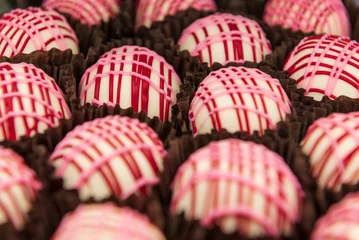  Selective focus shot of delicious red and white cupcakes place beside each other in a bakery © Adrian De La Paz/Wirestock Creators