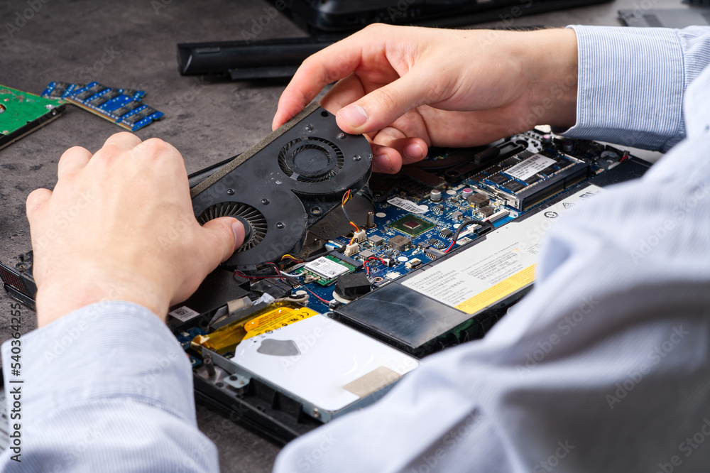 Poster hands fixing motherboard of pc or laptop notebook close up in service. laptop repair service. pc har