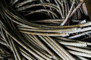 Ends of twisted rope metal wires stacked in warehouse