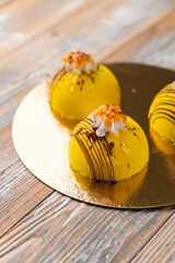 Yellow velvet patisseries on a golden tray