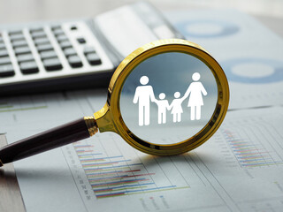 magnifying glass at the family Planning for life insurance or health for children Make a financial...