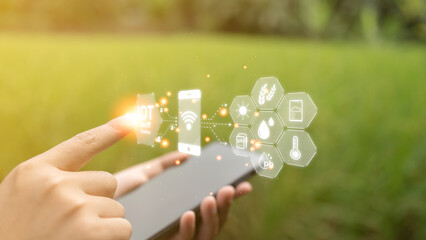 Farmer's hands are tapping on the virtual screen to analyze various factors in agricultural...