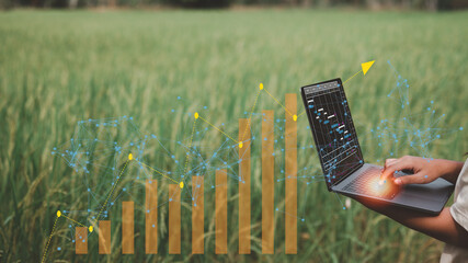 technology and agricultural concept, farmers hand holding a laptop to collecting and analysing data...