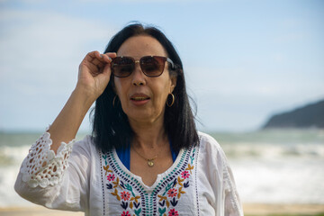 brazilian elderly woman enjoying beach trip