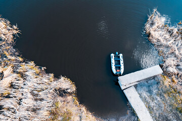 top view of the boat standing in the reeds on the pier