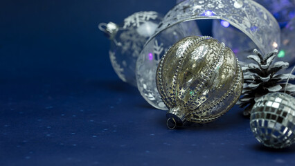beautiful glittering silver christmas baubles on dark blue background.