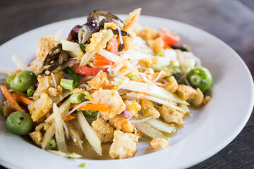 Som tum Thai is an incredibly popular Thai salad made of shredded green papaya.