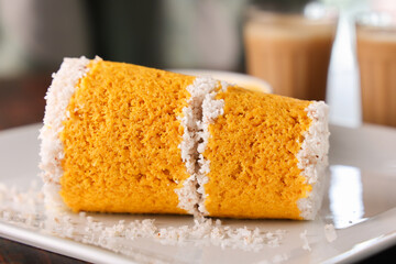 Popular South Indian breakfast puttu pittu made of corn flour and coconut in a bamboo mould, with...