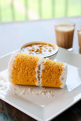 Popular South Indian breakfast puttu pittu made of corn flour and coconut in a bamboo mould, with banana, Kerala, India. Bamboo puttu prepared in the bamboo utensil.