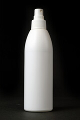 Plastic aerosol spray white bottle on dark background