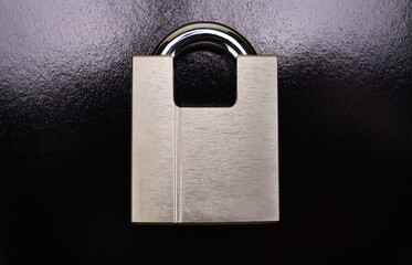 Chrome padlock on a black background.